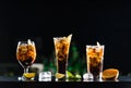 Alcoholic beverages whiskey and ÃÂola in glasses of different shapes on the bar table. Royalty Free Stock Photo